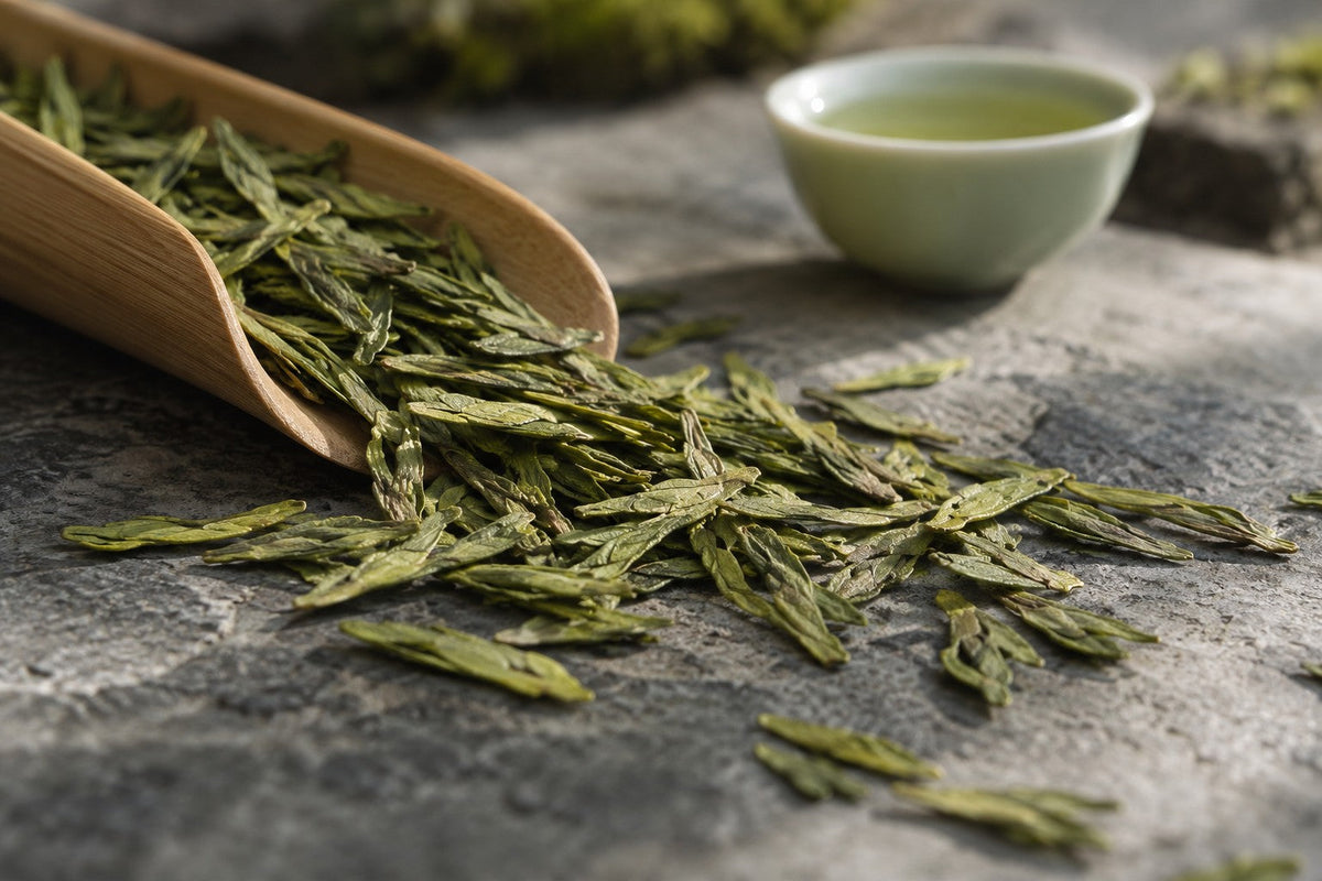 Flat green Long Jing leaves spilling from a bamboo scoop