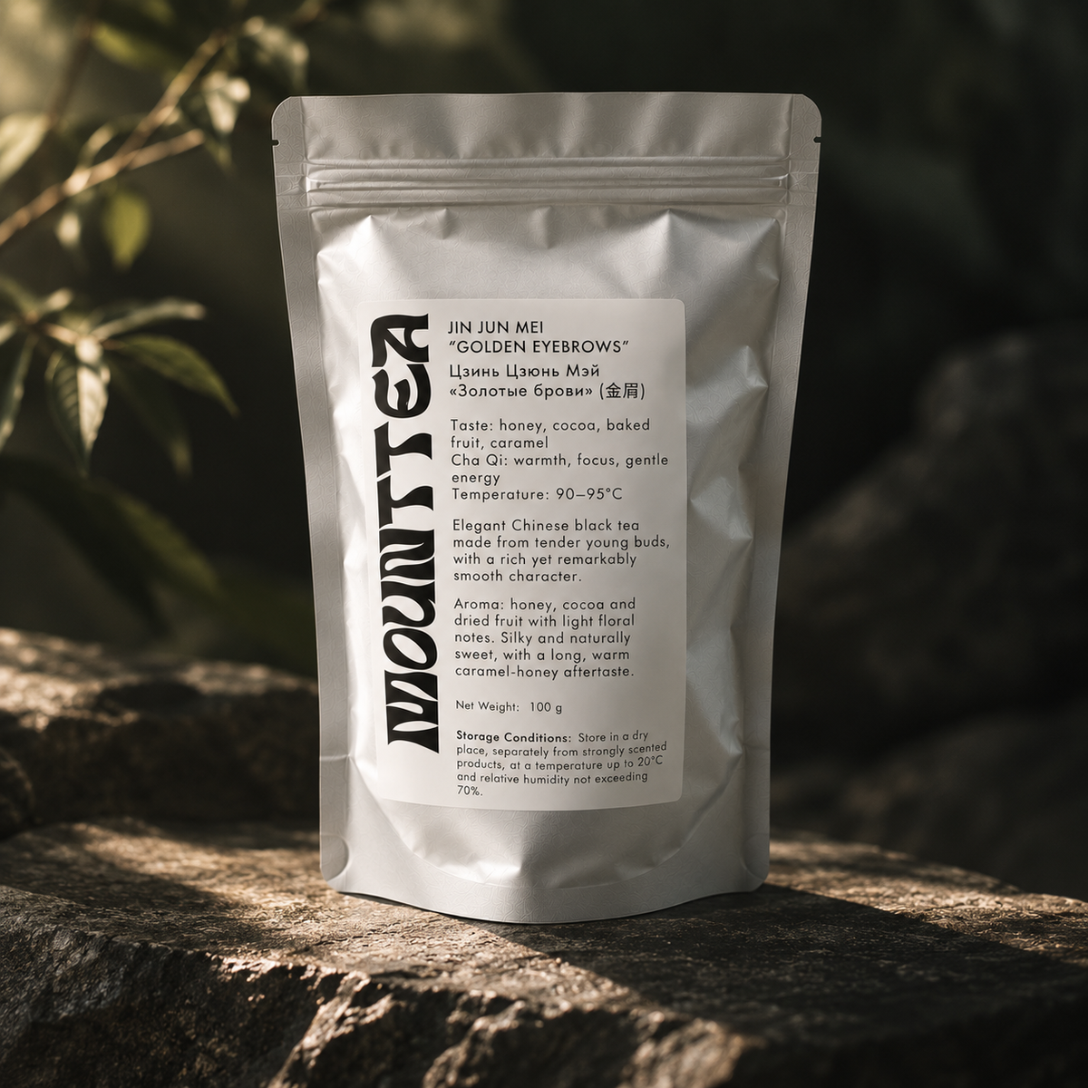 Jin Jun Mei black tea pouch among green foliage