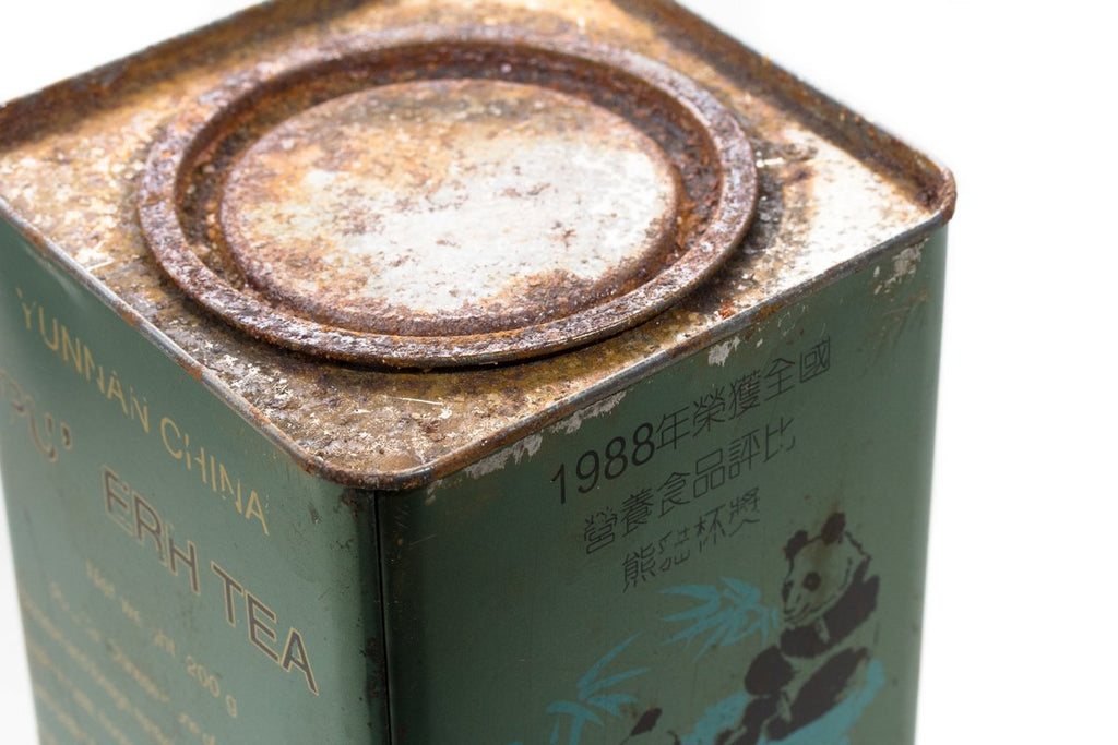 Close-up of the lid of a green Big Panda Pu-erh tea tin