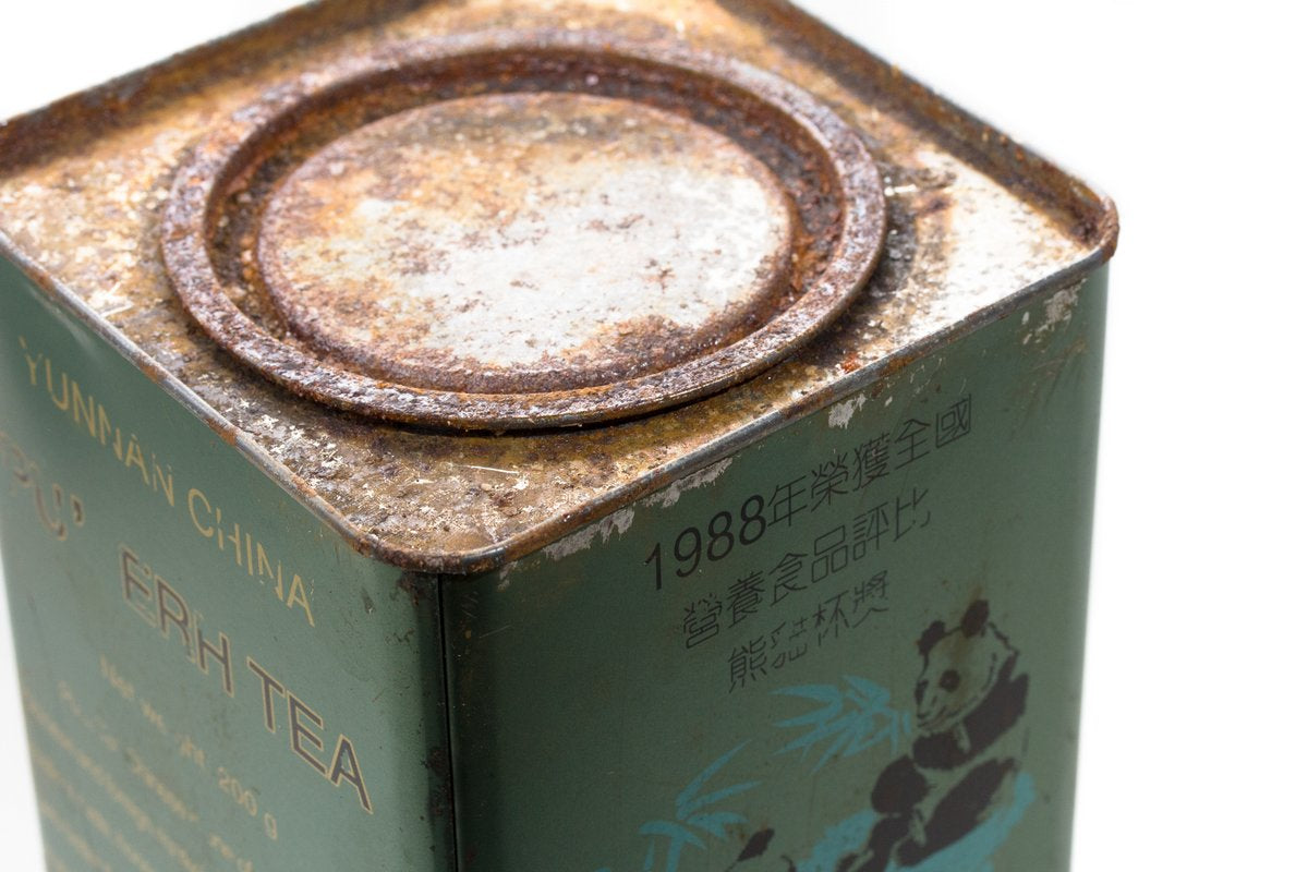 Close-up of the lid of a green Big Panda Pu-erh tea tin