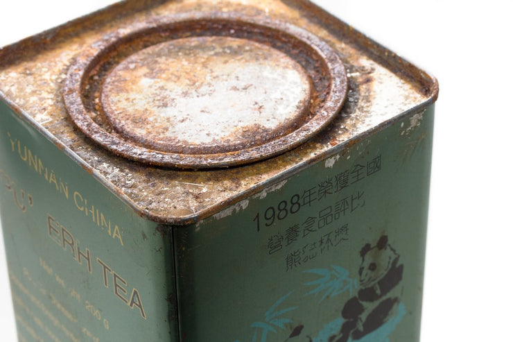 Close-up of the lid of a green Big Panda Pu-erh tea tin