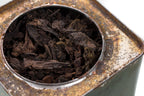 Open Big Panda tea tin filled with aged Pu-erh leaves