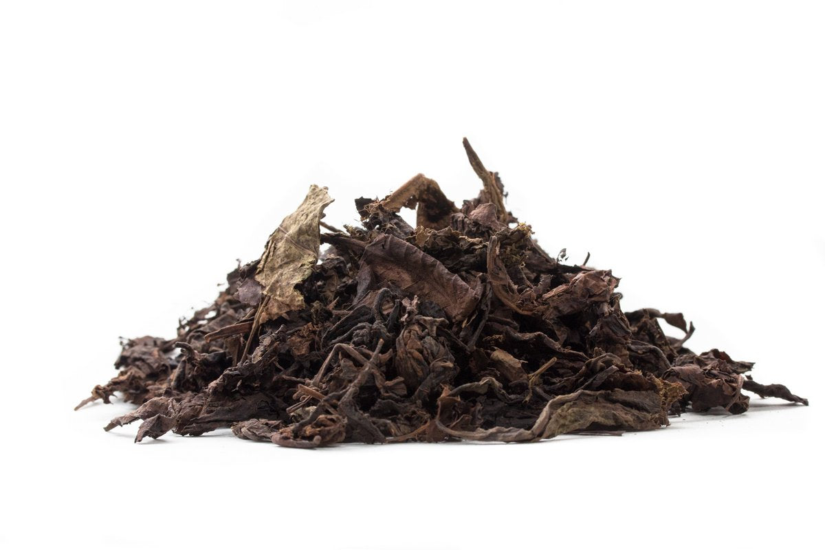 Big Panda aged ripe Pu-erh leaves on a white background