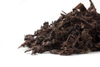 Side view of a pile of Big Panda aged Pu-erh leaves