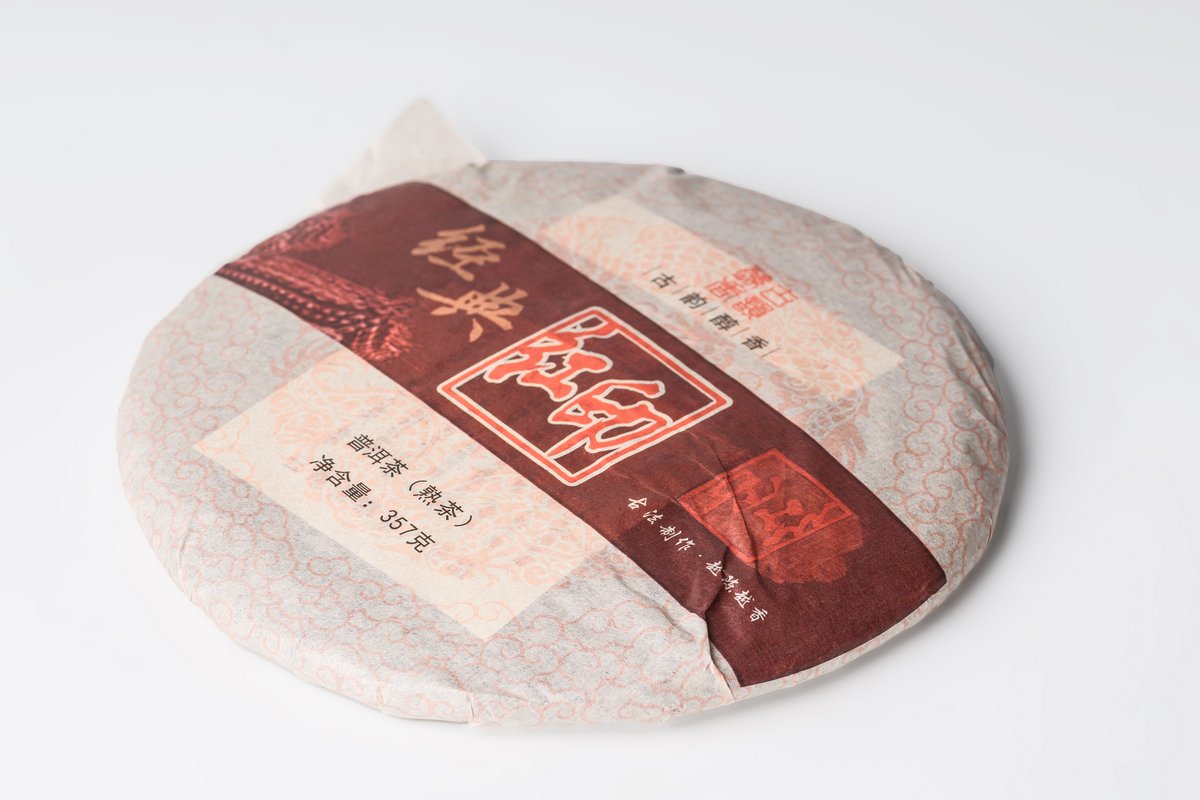 Gui Zhu Red Seal wrapped Pu-erh cake, angled view