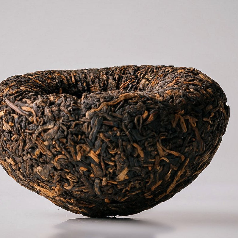 Unwrapped Menghai Dayi V93 ripe Pu-erh tuocha, side view