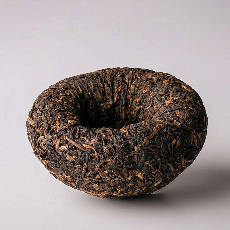 Menghai Dayi V93 ripe Pu-erh tuocha showing its central hollow